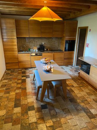 Self catering kitchen, a bit dark, down some stairs in the Centaure cottage at the Domaine des Etangs.