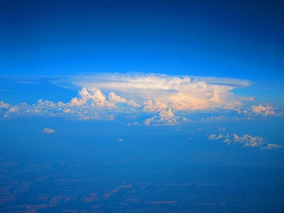 Saw this formation probably over or near The Rockies heading towards LAX. Seems to be something forming above existing clouds.