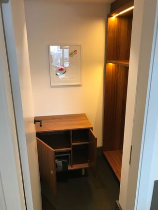 Extra coatroom next to wetbar, has a standard safe