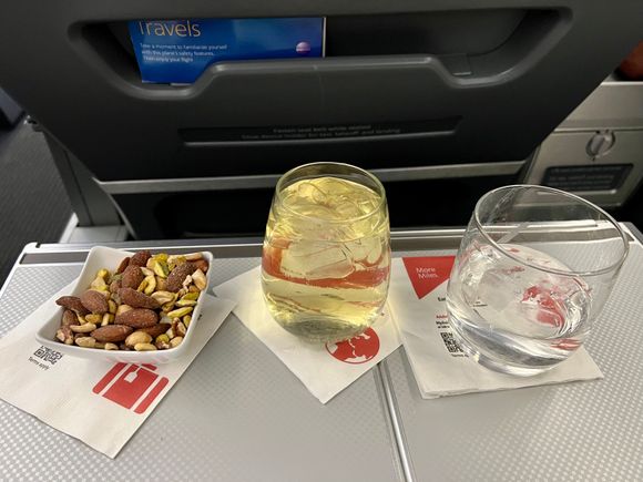 FA attentive and friendly.  Acknowledged by name and pre order confirmed.  Did many passes throughout flight.  White wine.  Nuts.  Water.  