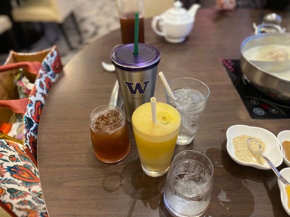 Herbal sour plum , red apple juice , glasses & tumbler of iced water