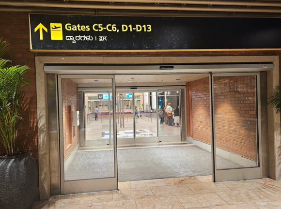 Sign pointing to gates C5 & C6 -- with the C3 sign clearly visible just beyond. VERY confusing.