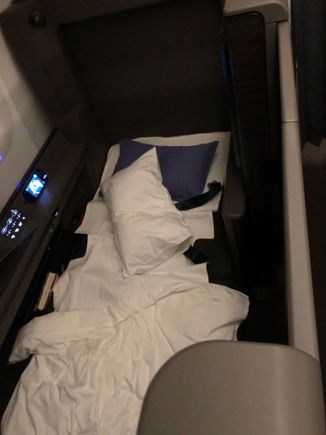 The flight attendant woke me up about 2 hours out of New York JFK. It was only now that I realized the suite actually had a door, and I rushed to get pictures before they cleaned up the bed!