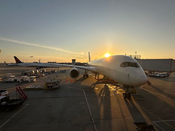 Beautiful evening at ATL with an A350 at the gate, a 767-400 taxiing out behind, and another A350 departing 27R during sunset. 