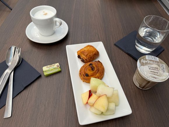 My guesthouse in Milan did not offer breakfast (plus I had to leave there around 6:30am for the 50km train ride to MXP), so I planned to eat at the lounge. Very so-so lounge and food, it would have scored a few more points had the yogurt not been practically as thin as whole milk. There was no granola but I ended up dumping some cocoa rice puff cereal in to make it edible.