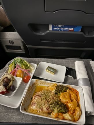 No pre-order when the upgrade clears a few hours before! I believe the on board options presented were Chicken Parmesan or... a pasta? I normally can remember but I was very tired. I noticed the Centennial Beef Wellington must have been on pre-order and several passengers had chosen it - it looked like they were enjoying it as well?