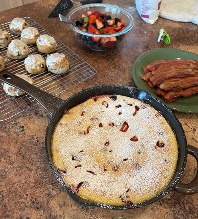 Mixed fruit clafoutis, cinnamon raisin biscuits, fruit, bacon for brunch. 