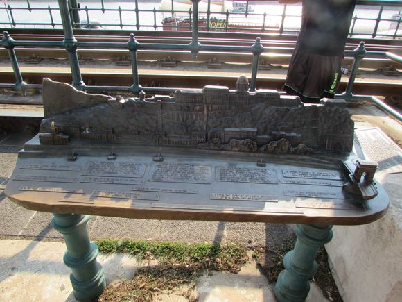 An ornate bench by the tram tracks which in turn run along the river in that part of town
