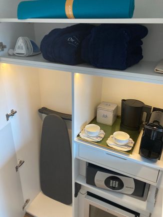 Directly left of the entry is the closet which has the iron+board, Kimpton's signature yogamat, robes + slippers, kettle, Nespresso machine