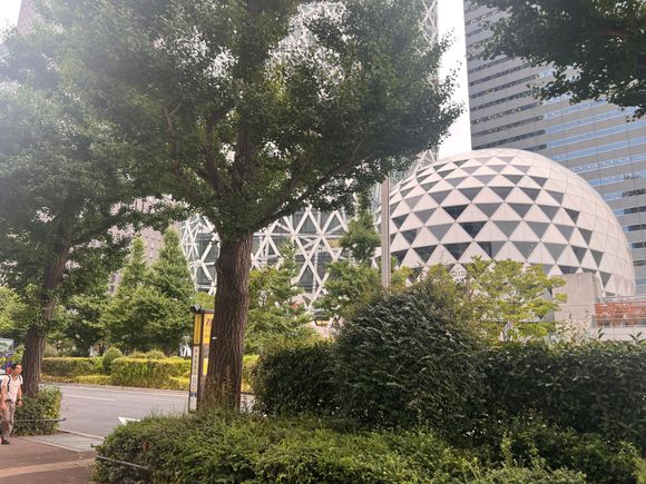 You will see several bus stop signs.  It is the last one behind this tree.  You will see Tokyo Mode across th street.  The one that looks like a faberge egg.
