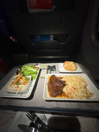 Shrimp, salad, short rib and a choice of bread basket, warm nuts and olives served. MIA-LAS on American.
