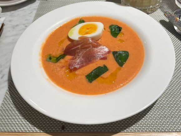 Chilled salmorejo soup with jamon serrano, soft egg and basil