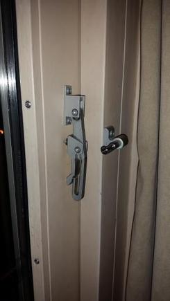 balcony door security latch, hanging down serving no purpose