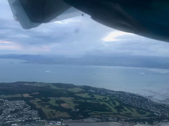 Towering cumulus with precipitation (and some spots of virga: precipitation that evaporates before it reaches the ground)  on approach into DUB on Aer Lingus flight. You can also see three ferries coming out of the harbour.