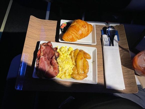 AS 188 ANC-SEA 1/2/24 Scrambled Eggs and Bacon with Roasted Potatoes, Croissant and Strawberry Jam. Light but filling. More than I could eat after stuffing myself at the ANC AL before the flight.