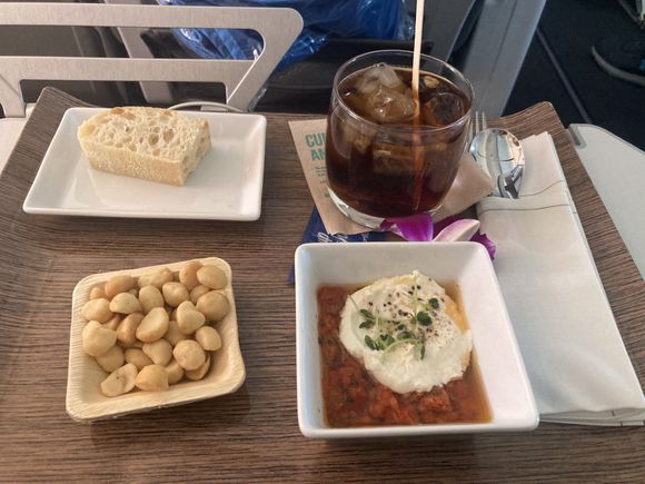 Inexperienced young flight attendant served cold nuts with a drink and bruschetta appetizer just 17 minutes after take off on a 6 hour flight to Hawaii.