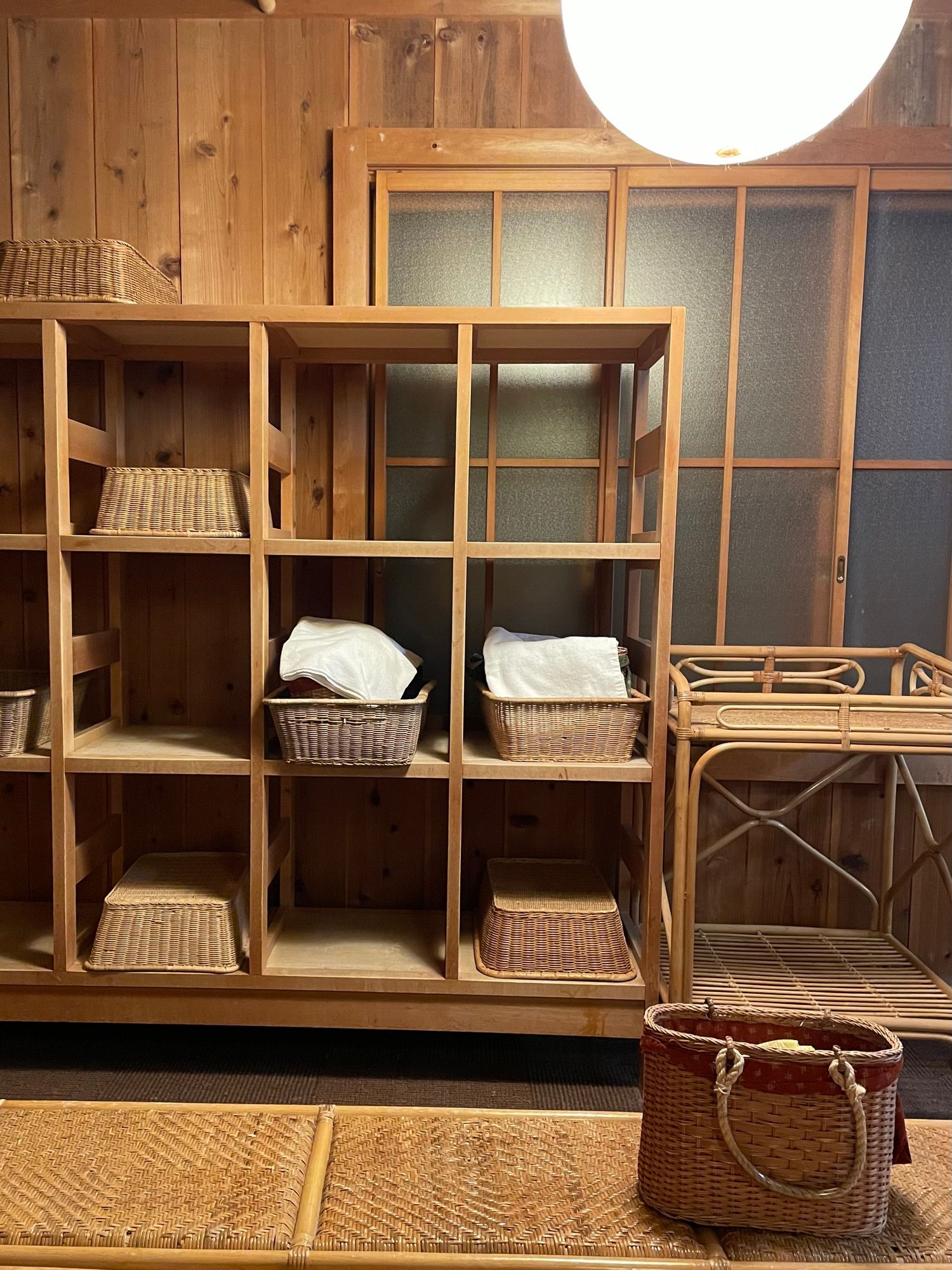 The womens indoor onsen room where one leaves their clothes in the basket before entering the bathing area. 