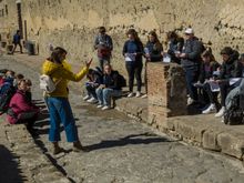 This Herculaneum tour guide explains about the ongoing excavations to a visiting high school group. She also explained how Herculaneum was a ritzy seaside resort destination--think Carmel. Archaeology buffs may also want to visit the Oplontis villa in nearby Torre Anunziata--the wall paintings there are fantastic.