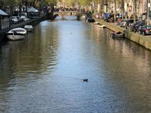 one of the dozens of canals. People and bikes galore on the streets of Amsterdam.