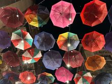 Umbrellas decorate the streets of the fish market, which turns into a restaurant zone at night
