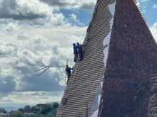 Workmen are restoring the roof