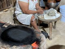 I swear this woman was smiling right before I took this photo.  Making tortillas by hand at Kinich