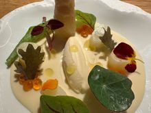 Standing tall--a spear of white asparagus from Tudela del Duero, near Valladolid.  According to our waiter, this town is the source of Spain's finest white asparagus.  In the center is asparagus ice cream (!) These, and the exquisite leaves and blossoms sit on a pool of ajoblanco, the traditional Malagueña cold soup.   Breathtaking to look at, and to taste!