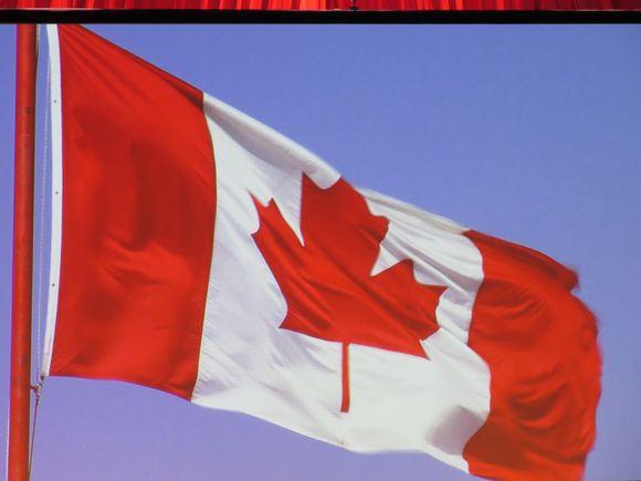 The Flag  is shown , everybody stand.
