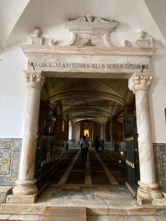The inscription over the doorway reads “We bones that are here await tours”!