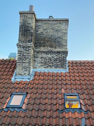 Looking at Sam in the bathroom window across the courtyard from the bedroom window. 