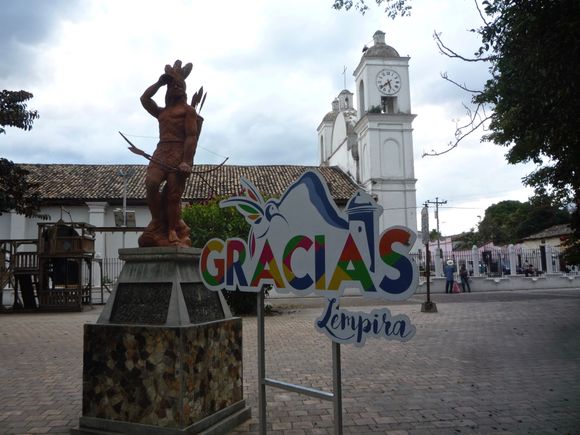 From the central plaza:  in the background, San Marcos church; and in the foreground, the Lenca war leader Lempira, who led the local resistance against the Spanish conquistadors. 