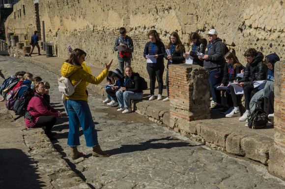 This Herculaneum tour guide explains about the ongoing excavations to a visiting high school group. She also explained how Herculaneum was a ritzy seaside resort destination--think Carmel. Archaeology buffs may also want to visit the Oplontis villa in nearby Torre Anunziata--the wall paintings there are fantastic.