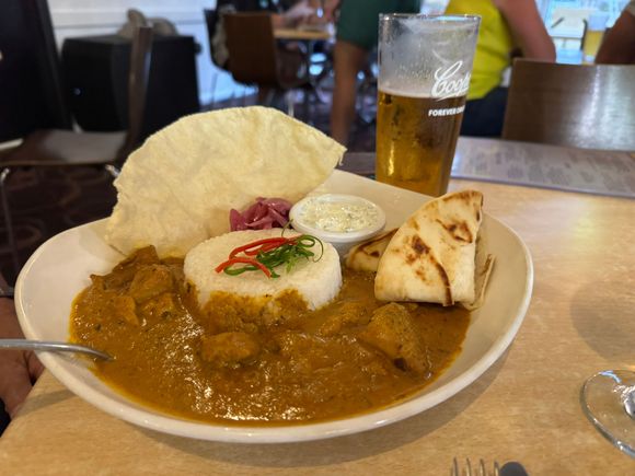 Ed's dinner - Caribbean chicken with curry, naan, rice, and pickled onion.