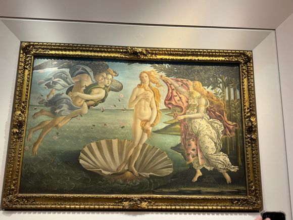 The very famous "Birth of Venus" by Botticelli. The Goddess of Love and Beauty arrives on land, on the island of Cyprus. She is born of the sea spray and blown there by the winds, Zephyr and Aura.