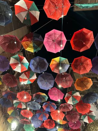 Umbrellas decorate the streets of the fish market, which turns into a restaurant zone at night