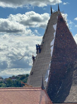 Workmen are restoring the roof