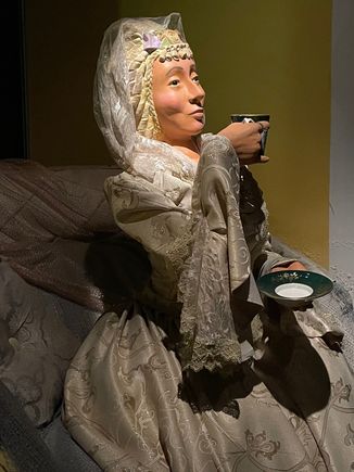 Only the rich drank chocolate of course, this woman was riding in a carriage.