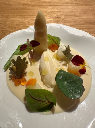 Standing tall--a spear of white asparagus from Tudela del Duero, near Valladolid.  According to our waiter, this town is the source of Spain's finest white asparagus.  In the center is asparagus ice cream (!) These, and the exquisite leaves and blossoms sit on a pool of ajoblanco, the traditional Malagueña cold soup.   Breathtaking to look at, and to taste!