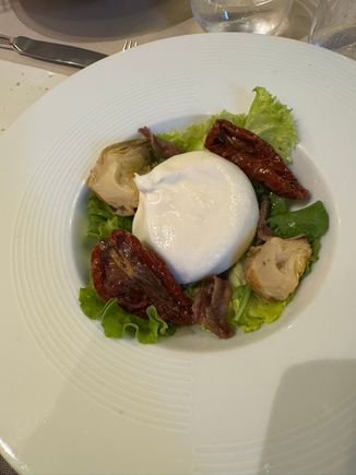 Our tasting menu at Olio - Fresh burrata starter with anchovies, artichokes, and sun dried tomatoes