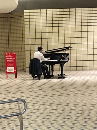 When I'm in the giant, spotless, bigger than a hallway, space, I'm hearing Chopin.  I get a little closer and there is an actual grand piano and some guy is playing Chopin. It's 8 in the morning!  Chopin didn't even get up before 10 o'clock