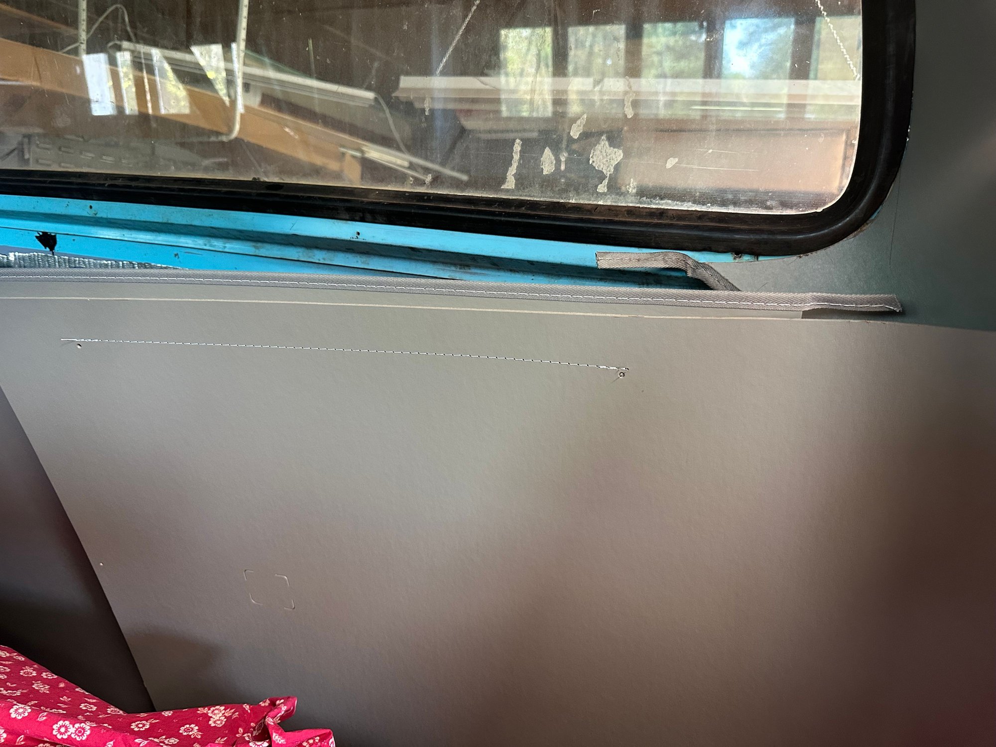 This is the top insert just put in place.  Where does it land in relation to the molding. It doesnt look like I goes under the molding with the fabric trim piece in place. 