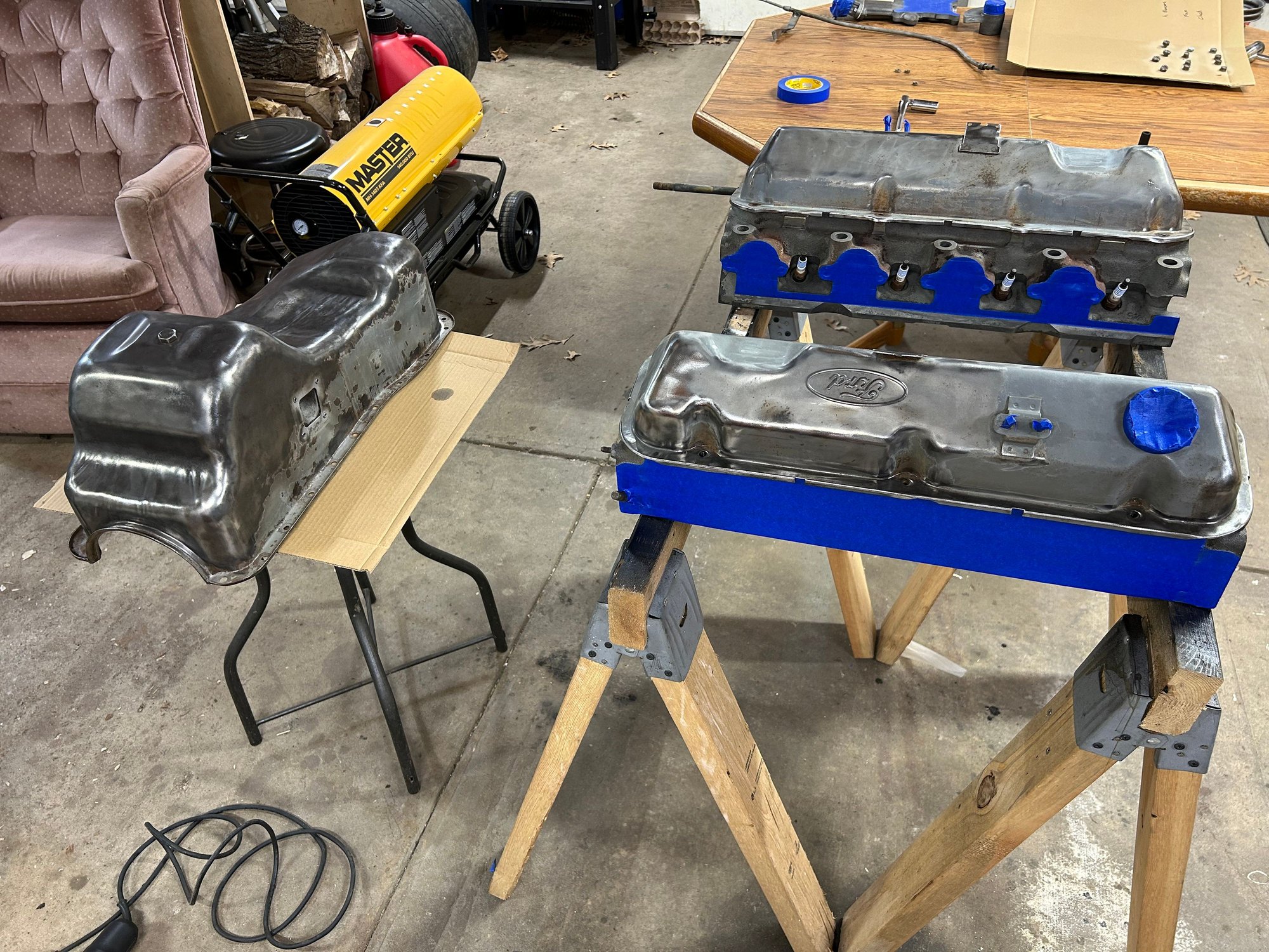 I taped off the heads getting them ready for paint. Also, some of the other small parts and then installed the spark plugs in the holes to keep any paint out of those then I got everything painted.