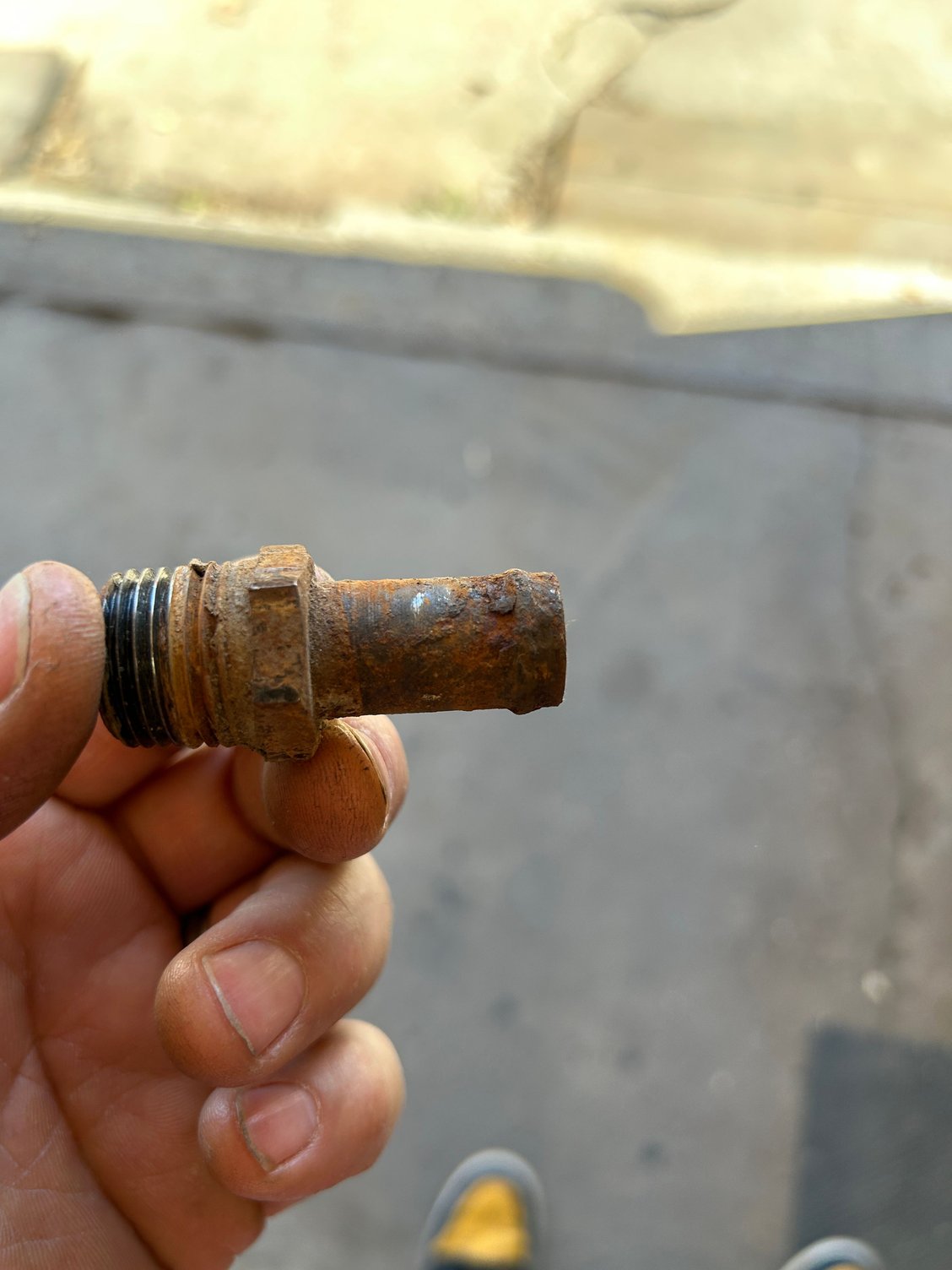 So to get things going, I pulled the nipple off of the old water pump. Got my bench grinder out with the wire wheel. I just have it mounted to a board and then I clamp it to my workbench when I need it and then I put it away when I�m done that way I have more room to do stuff. But I went ahead and cleaned up the nipple with the wire brush and got it looking pretty good.