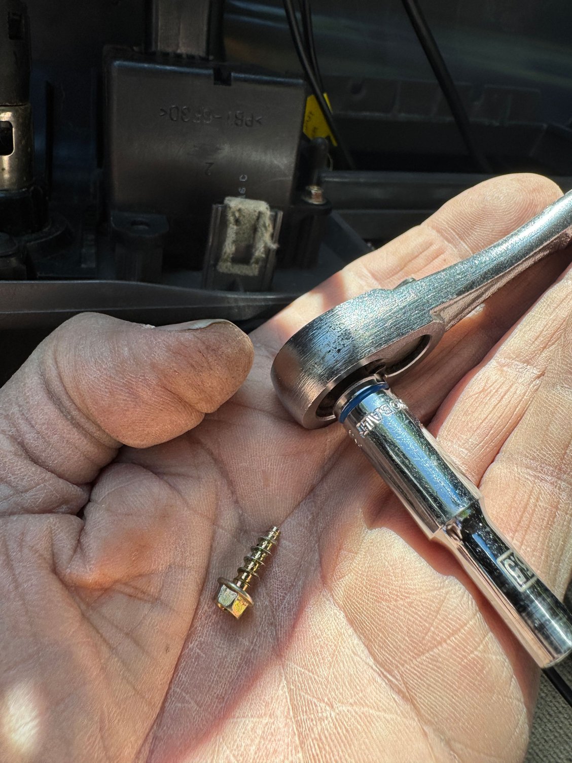 secure the black plastic assembly to the back of the dash surround,