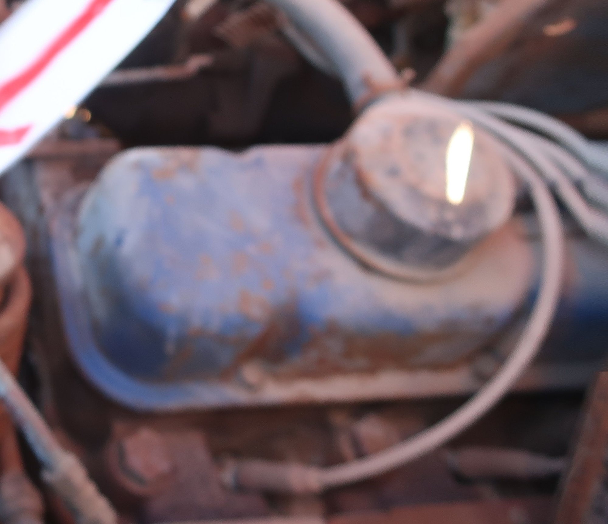 The arrow is pointing to the power steering fill cap. I haven't located the oil fill cap.