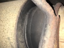 The gap at the bottom of the muffler.