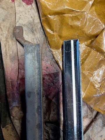 Close up of subject area showing original piece with the protrusion (on both ends) and the new aftermarket replacement without the protrusions.