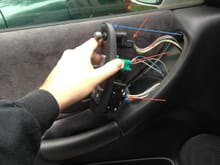 To remove the door panel, lift off and unplug the driver's switches.