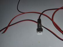 the led  is meant for panel mounting so it has a adjustable knurled/threaded backing.