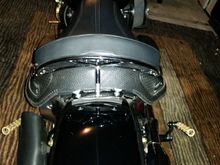 Aftermarket low rise grab rail back rest. Not an out of the box fix as a reviews stated, had to spread the grab rail and add a 1 inch threaded spacer to allow for real seat clearance.